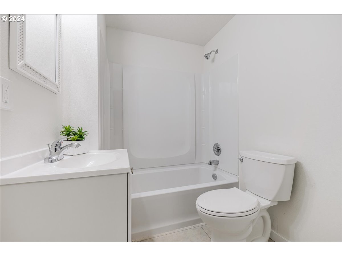 711 Southeast 5th Street Gresham, OR 97080 - Photo 26 of 44 a bathroom with a sink a toilet and bathtub