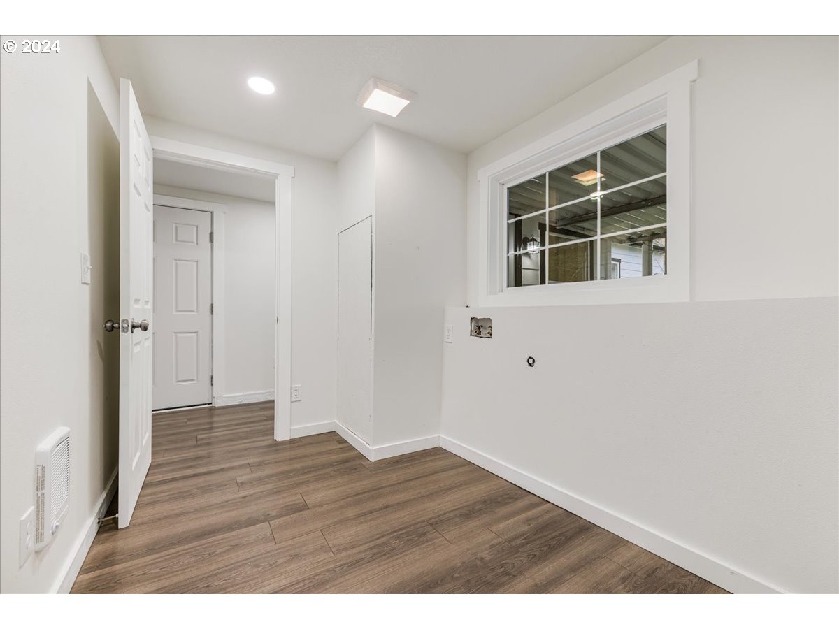711 Southeast 5th Street Gresham, OR 97080 - Photo 28 of 44 a view of an empty room with wooden floor and a window