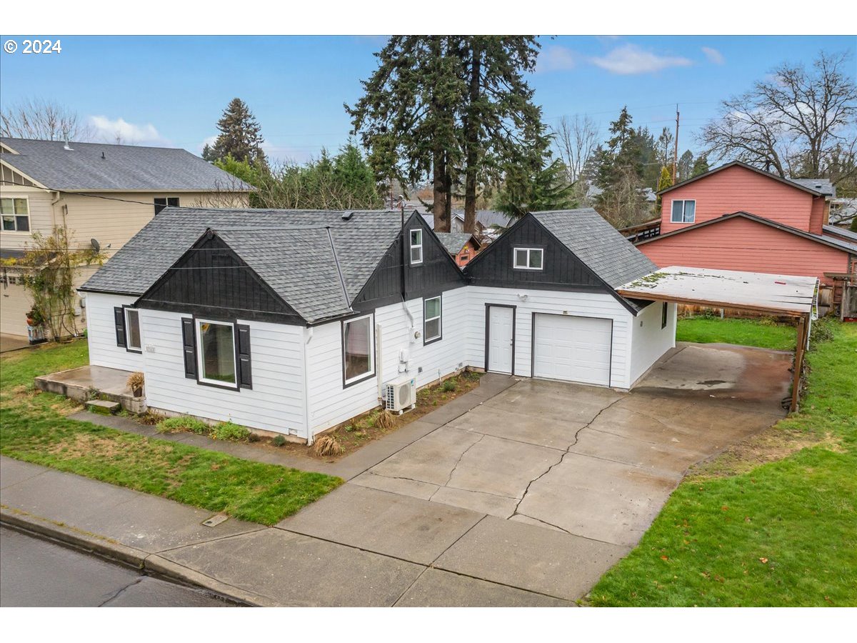 711 Southeast 5th Street Gresham, OR 97080 - Photo 3 of 44 a front view of a house with a yard and garage
