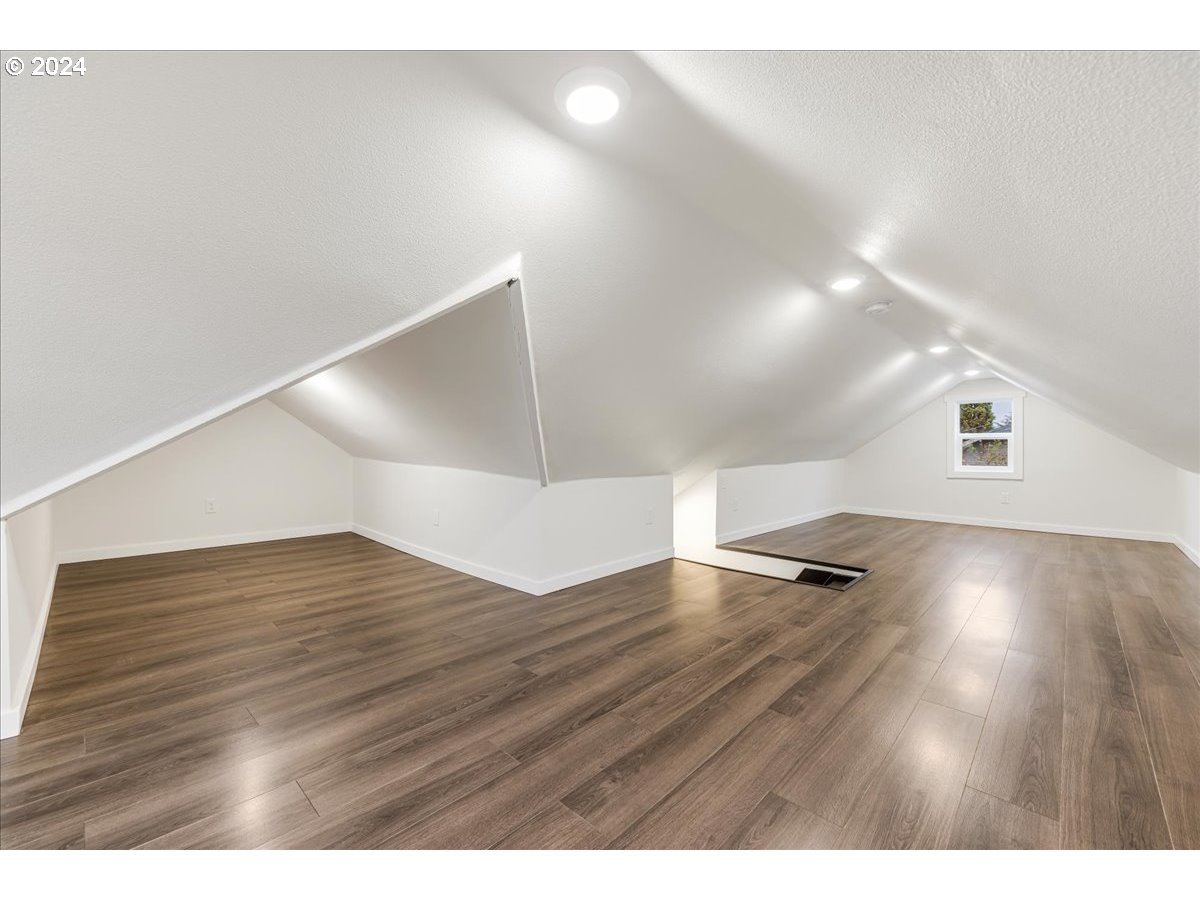 711 Southeast 5th Street Gresham, OR 97080 - Photo 34 of 44 a view of an empty room with wooden floor and a window