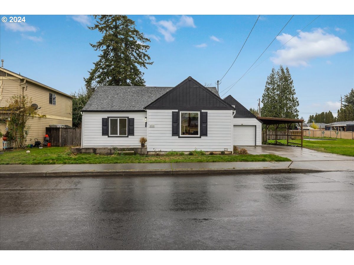 711 Southeast 5th Street Gresham, OR 97080 - Photo 4 of 44 a front view of a house with a garden and lake view
