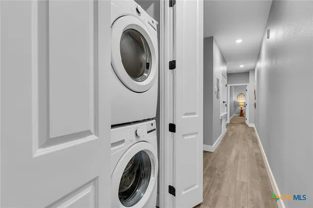 a view of a hallway with washer and dryer