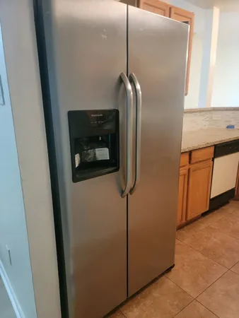 a close view of a utility room with dryer and washer