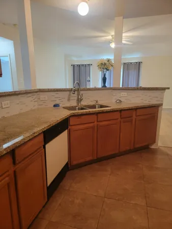 a spacious bathroom with a granite countertop sink and a mirror
