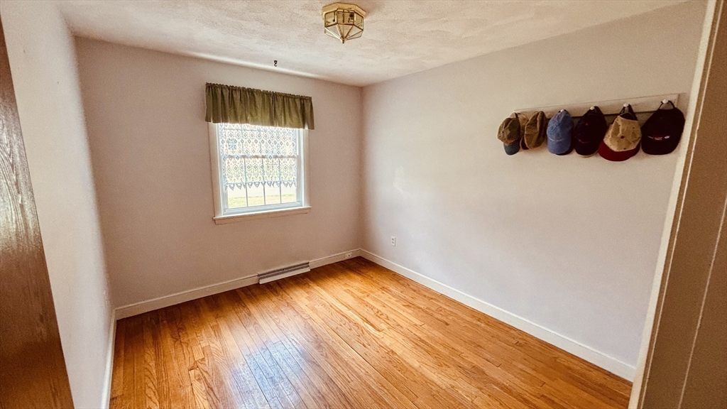 29 Forest Street Franklin, MA 02038 - Photo 16 of 19 a view of an empty room with wooden floor and a window