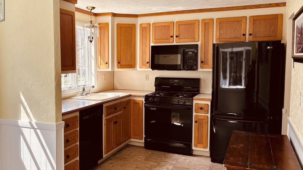 29 Forest Street Franklin, MA 02038 - Photo 4 of 19 a kitchen with stainless steel appliances granite countertop a refrigerator and a sink