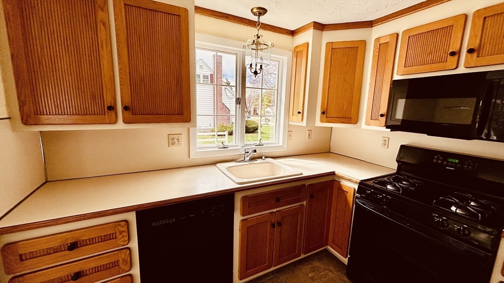 29 Forest Street Franklin, MA 02038 - Photo 5 of 19 a kitchen with a sink stove top oven and cabinets
