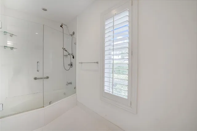 a bathroom with a bathtub and shower