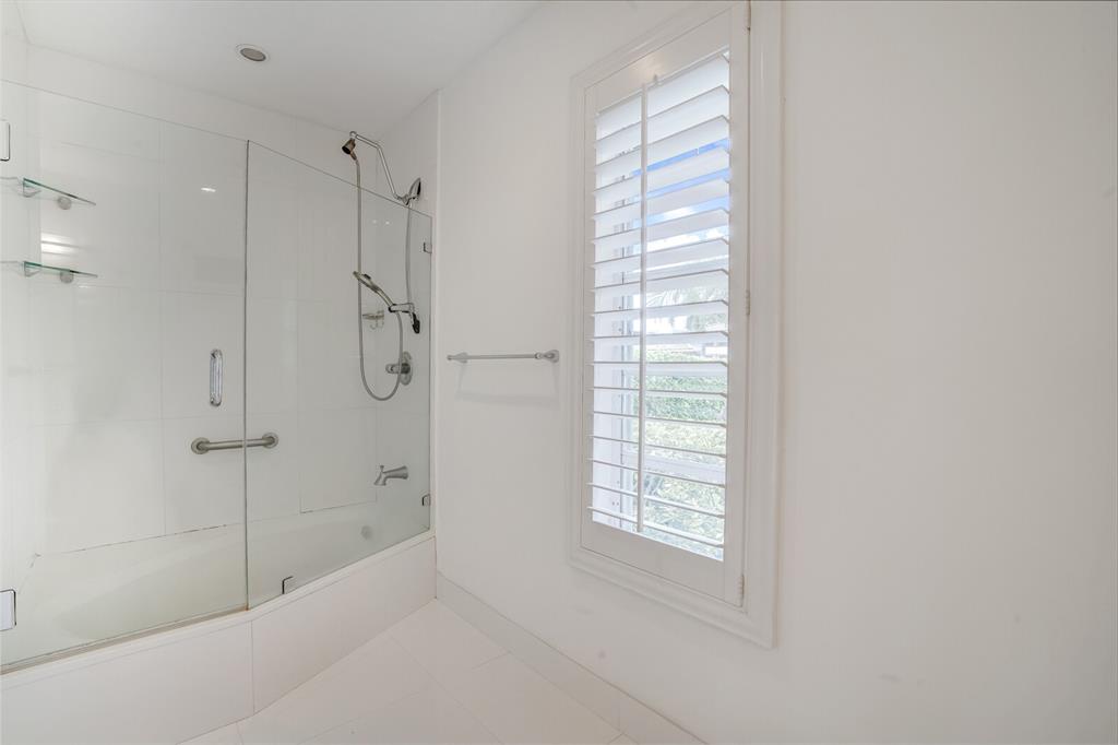 3721 Northeast 29th Avenue Lighthouse Point, FL 33064 - Photo 16 of 43 a bathroom with a bathtub and shower