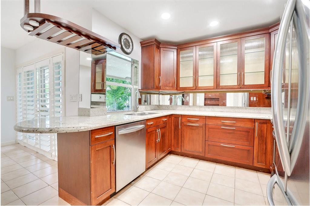 3721 Northeast 29th Avenue Lighthouse Point, FL 33064 - Photo 18 of 43 a kitchen with stainless steel appliances granite countertop a sink and cabinets