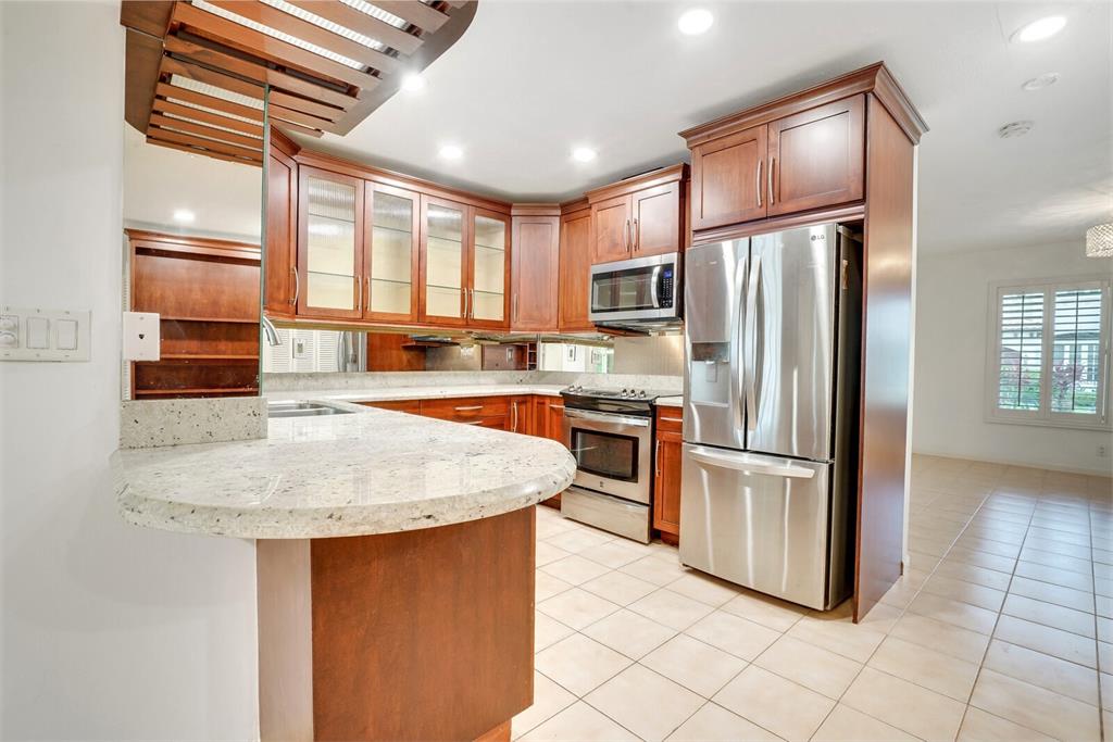 3721 Northeast 29th Avenue Lighthouse Point, FL 33064 - Photo 19 of 43 a kitchen with stainless steel appliances granite countertop a refrigerator a stove a sink and a refrigerator
