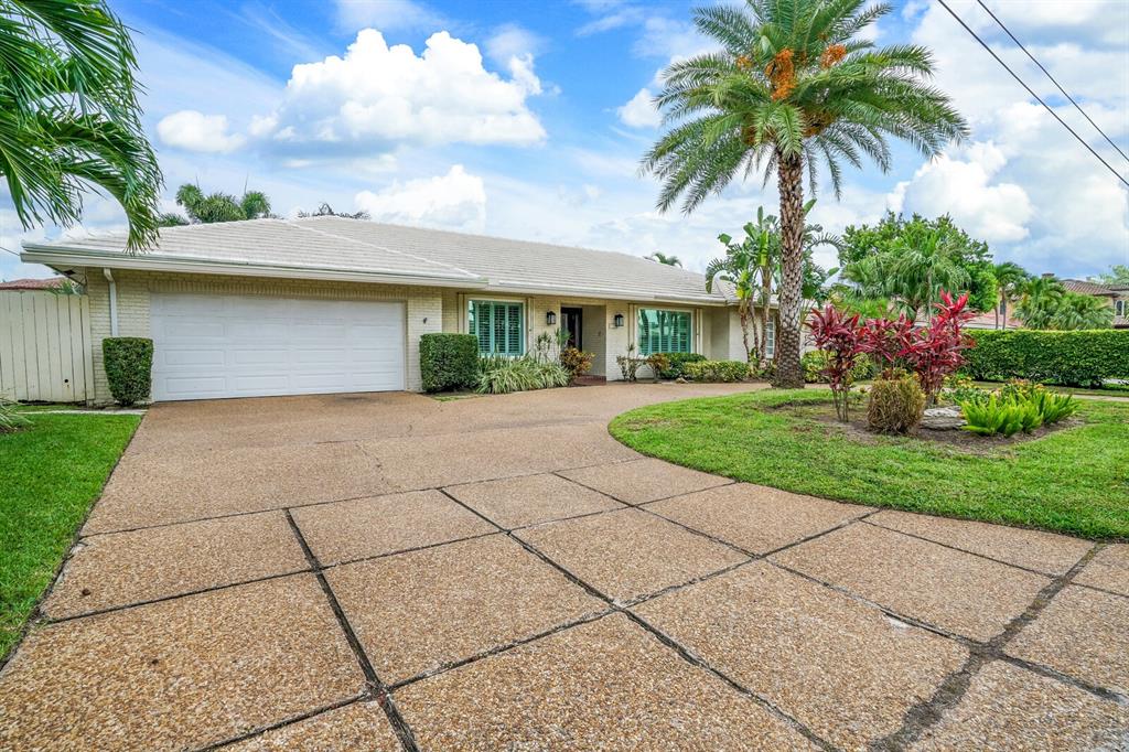 3721 Northeast 29th Avenue Lighthouse Point, FL 33064 - Photo 2 of 43 a front view of house with yard and green space