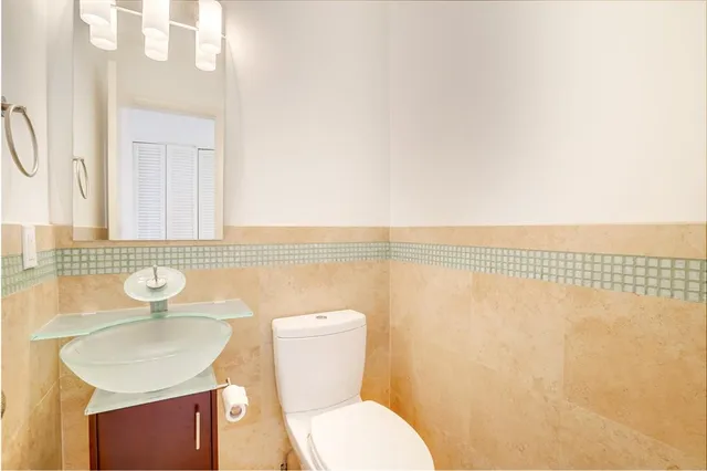 a bathroom with a sink a toilet and shower curtain