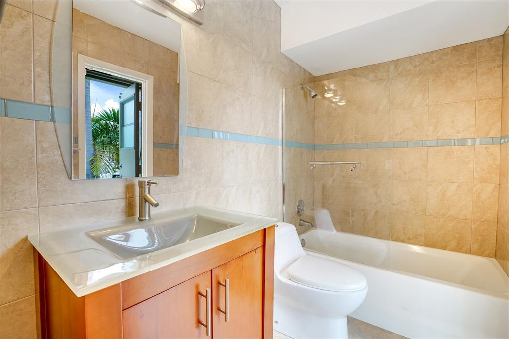 3721 Northeast 29th Avenue Lighthouse Point, FL 33064 - Photo 31 of 43 a bathroom with a sink toilet and shower