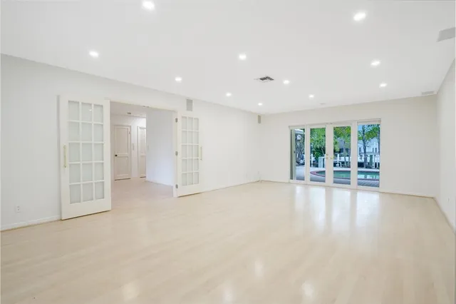 an empty room with large windows