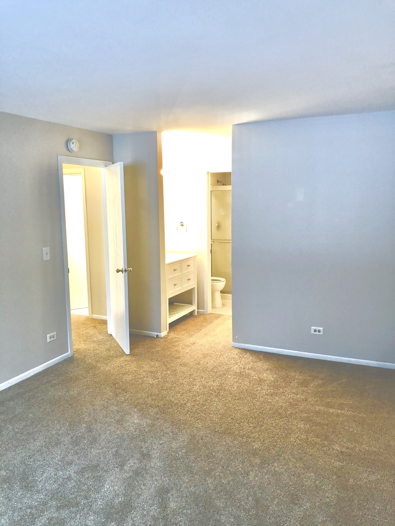 2017 Windemere Circle, Unit 2017 Schaumburg, IL 60169 - Photo 11 of 15 a view of an empty room with a window