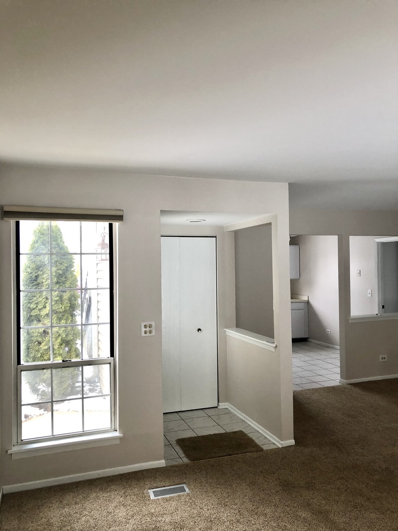 2017 Windemere Circle, Unit 2017 Schaumburg, IL 60169 - Photo 7 of 15 an empty room with windows and closet