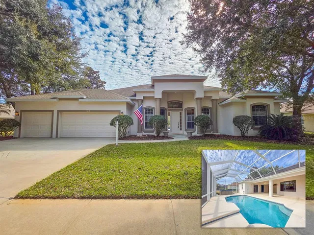 a view of a house with swimming pool and a chairs and table in a patio