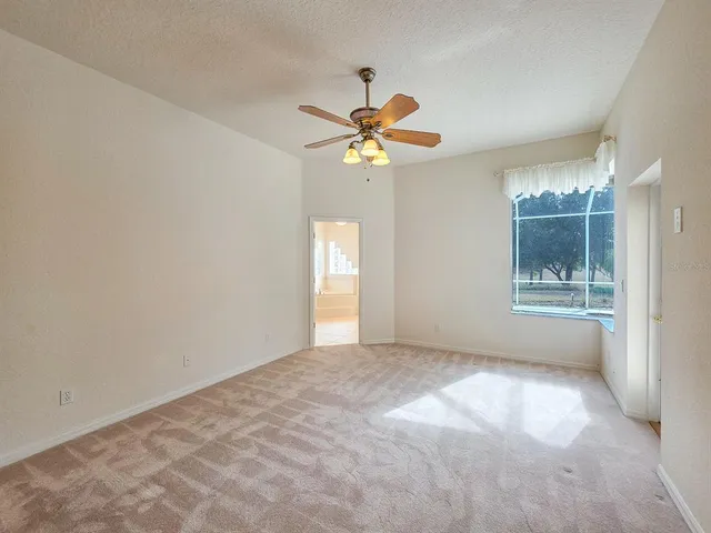 a spacious bathroom with a tub sink and mirror