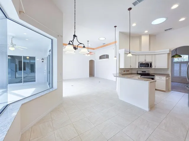 a kitchen with stainless steel appliances a sink stove and refrigerator