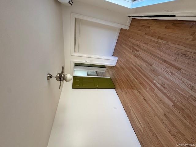 103-14 169th Street Queens, NY 11433 - Photo 12 of 18 an empty room with wooden floor and ceiling fan