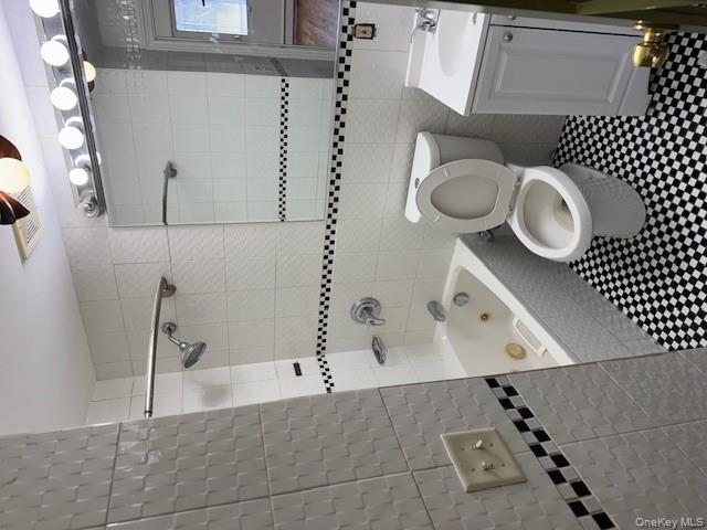 103-14 169th Street Queens, NY 11433 - Photo 17 of 18 a bathroom with a toilet a sink and bathtub