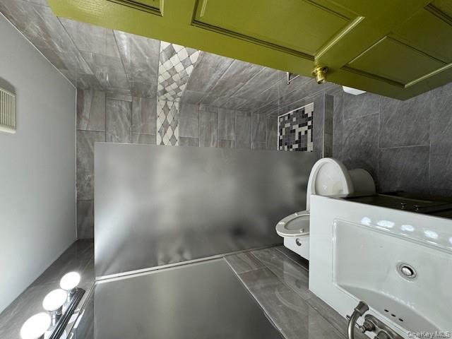 103-14 169th Street Queens, NY 11433 - Photo 9 of 18 a bathroom with a sink and a shower