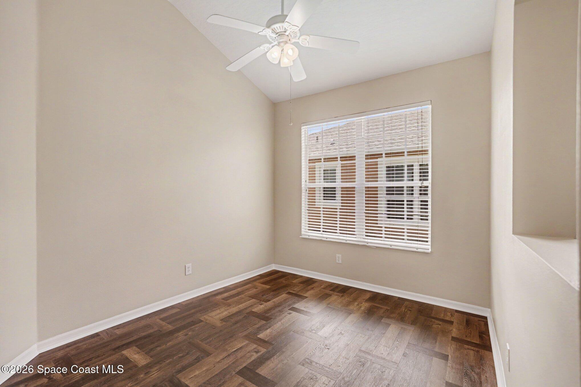 284 Intrepid Way Indialantic, FL 32903 - Photo 10 of 36 an empty room with wooden floor ceiling fan and windows