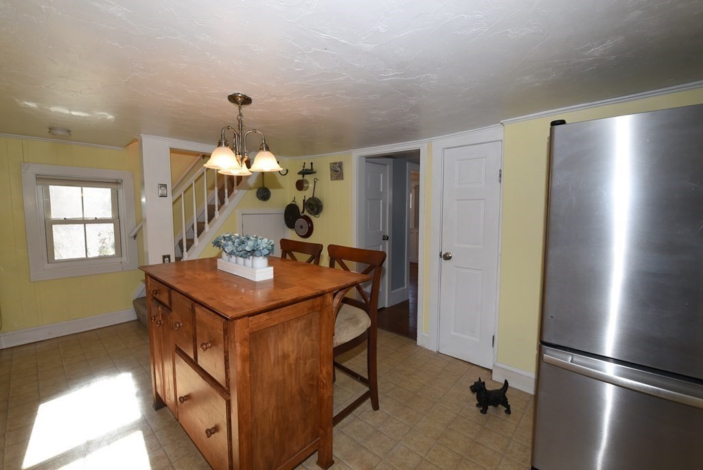 7 Summer Street Kingston, MA 02364 - Photo 15 of 41 a kitchen with stainless steel appliances kitchen island granite countertop a refrigerator a stove and a sink