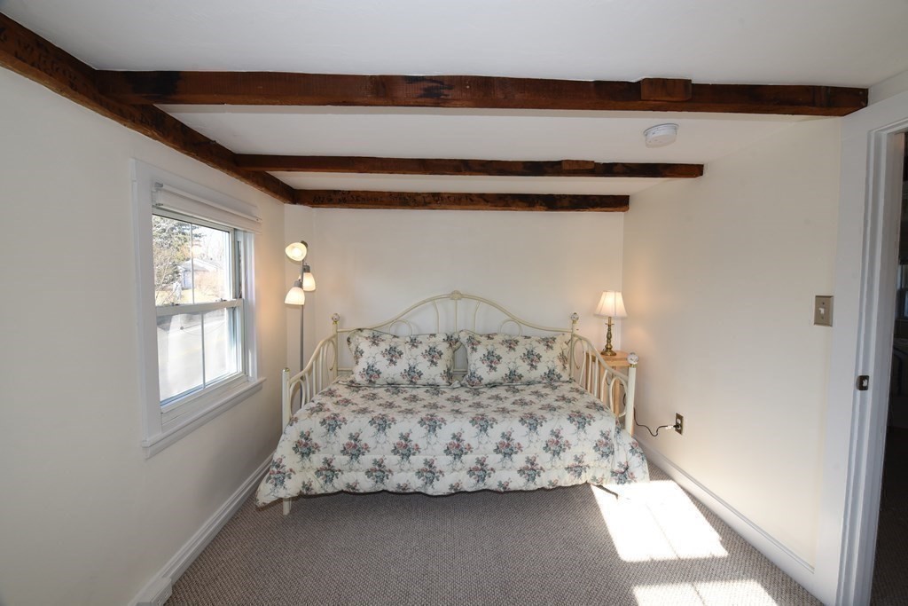 7 Summer Street Kingston, MA 02364 - Photo 28 of 41 a bed sitting in a bedroom next to a window