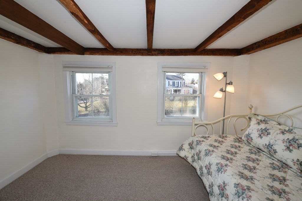 7 Summer Street Kingston, MA 02364 - Photo 29 of 41 a bed sitting in a bedroom next to a window