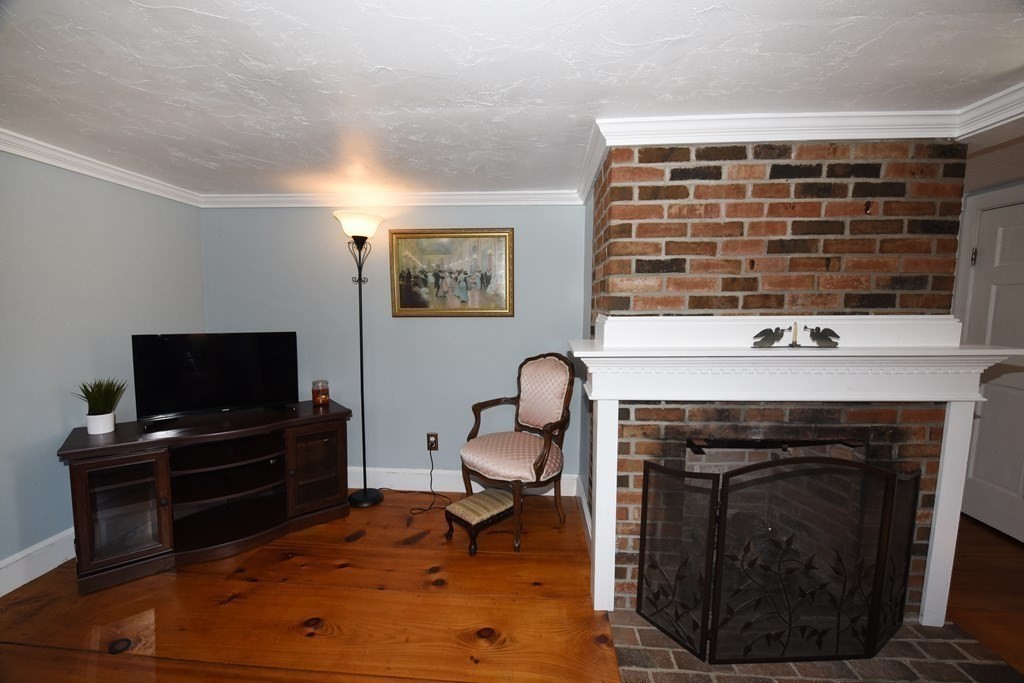 7 Summer Street Kingston, MA 02364 - Photo 7 of 41 a living room with furniture a flat screen tv and a fireplace