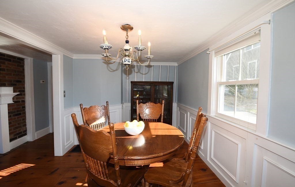 7 Summer Street Kingston, MA 02364 - Photo 10 of 41 a dining room with furniture a rug a fireplace and wooden floor