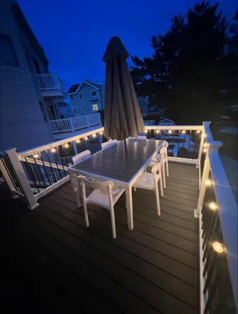 a view of backyard with outdoor seating and wooden floor