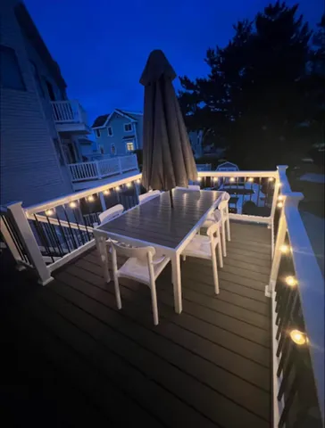 a view of backyard with outdoor seating and wooden floor