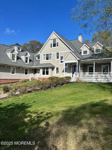a front view of a house with a yard table and chairs