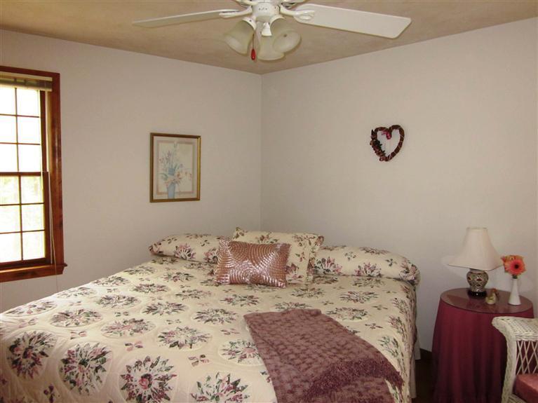 64 Day Road Wellfleet, MA 02667 - Photo 6 of 24 a bedroom with a bed and a chandelier