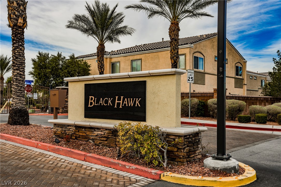 6320 Snap Ridge Street, Unit 201 North Las Vegas, NV 89081 - Photo 38 of 56 Secure community entrance with established landscaping and stately palm trees.