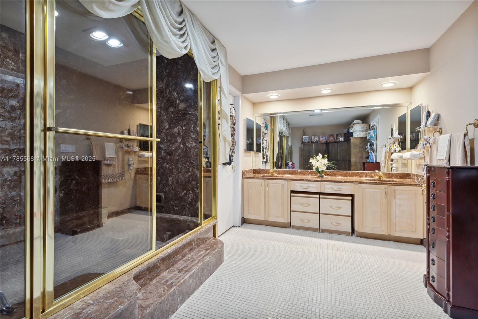 16634 Golfview Drive Weston, FL 33326 - Photo 14 of 29 a bathroom with a glass shower door and a sink