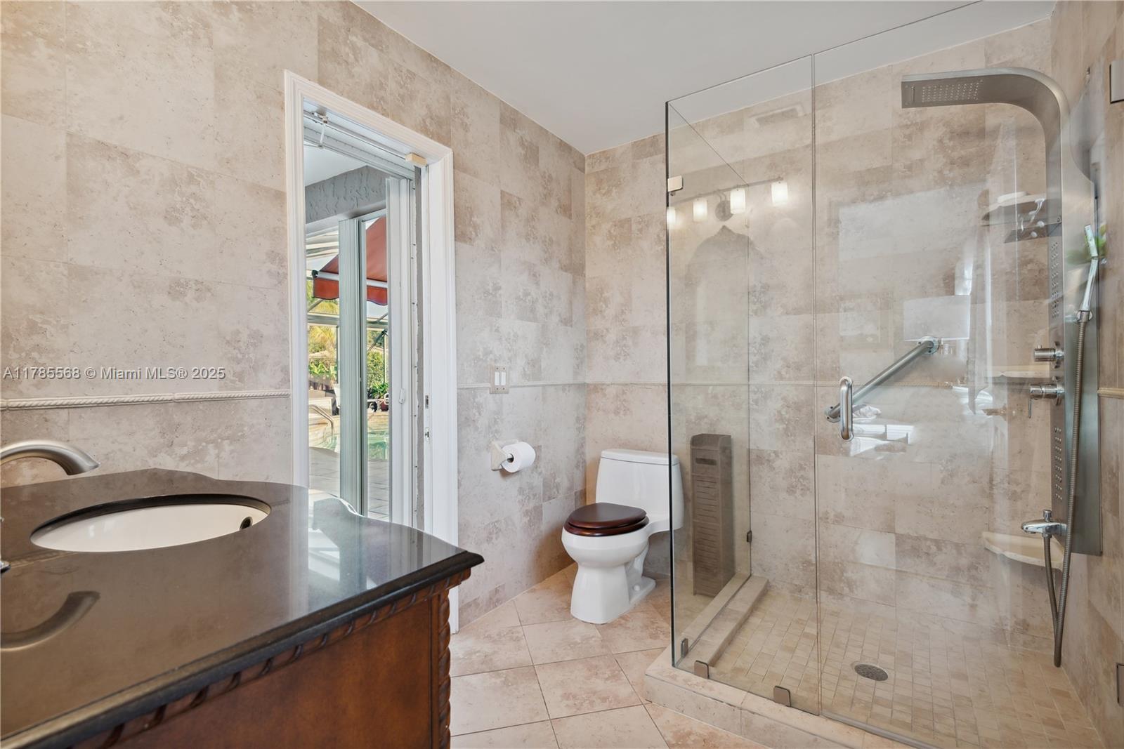 16634 Golfview Drive Weston, FL 33326 - Photo 20 of 29 a bathroom with a granite countertop sink a toilet and shower