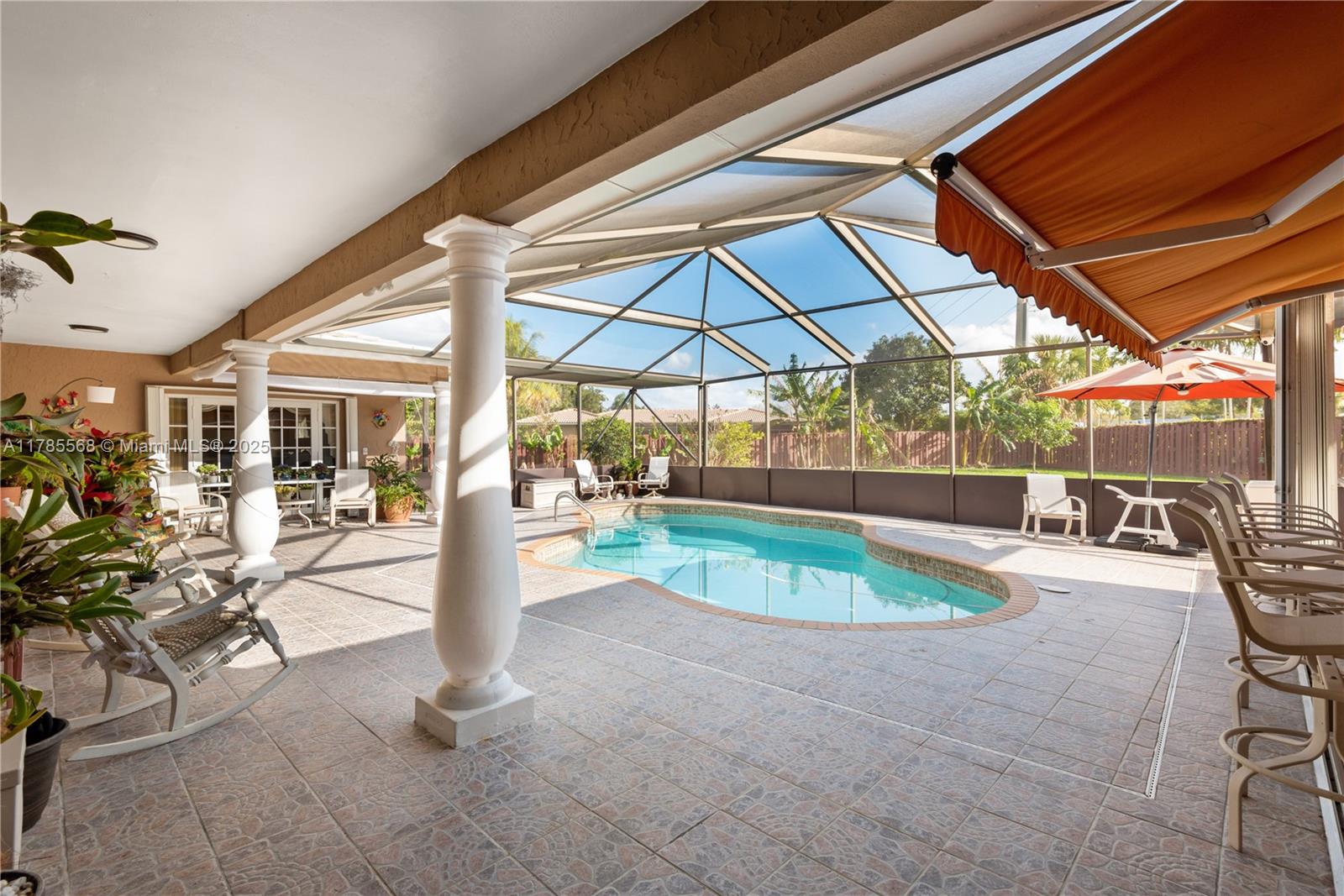 16634 Golfview Drive Weston, FL 33326 - Photo 21 of 29 a view of a swimming pool with a patio and a backyard