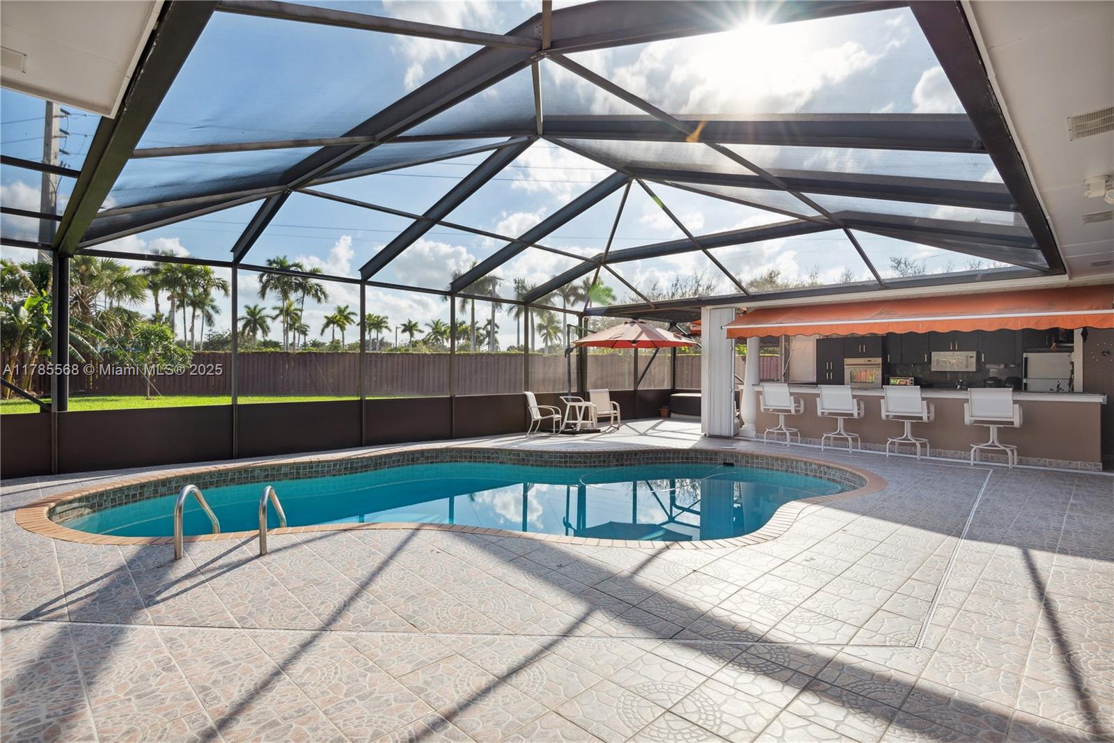 16634 Golfview Drive Weston, FL 33326 - Photo 23 of 29 a view of a swimming pool with a patio