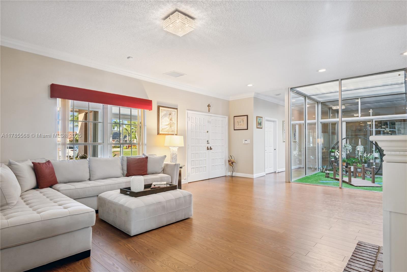 16634 Golfview Drive Weston, FL 33326 - Photo 5 of 29 a living room with furniture and a large window