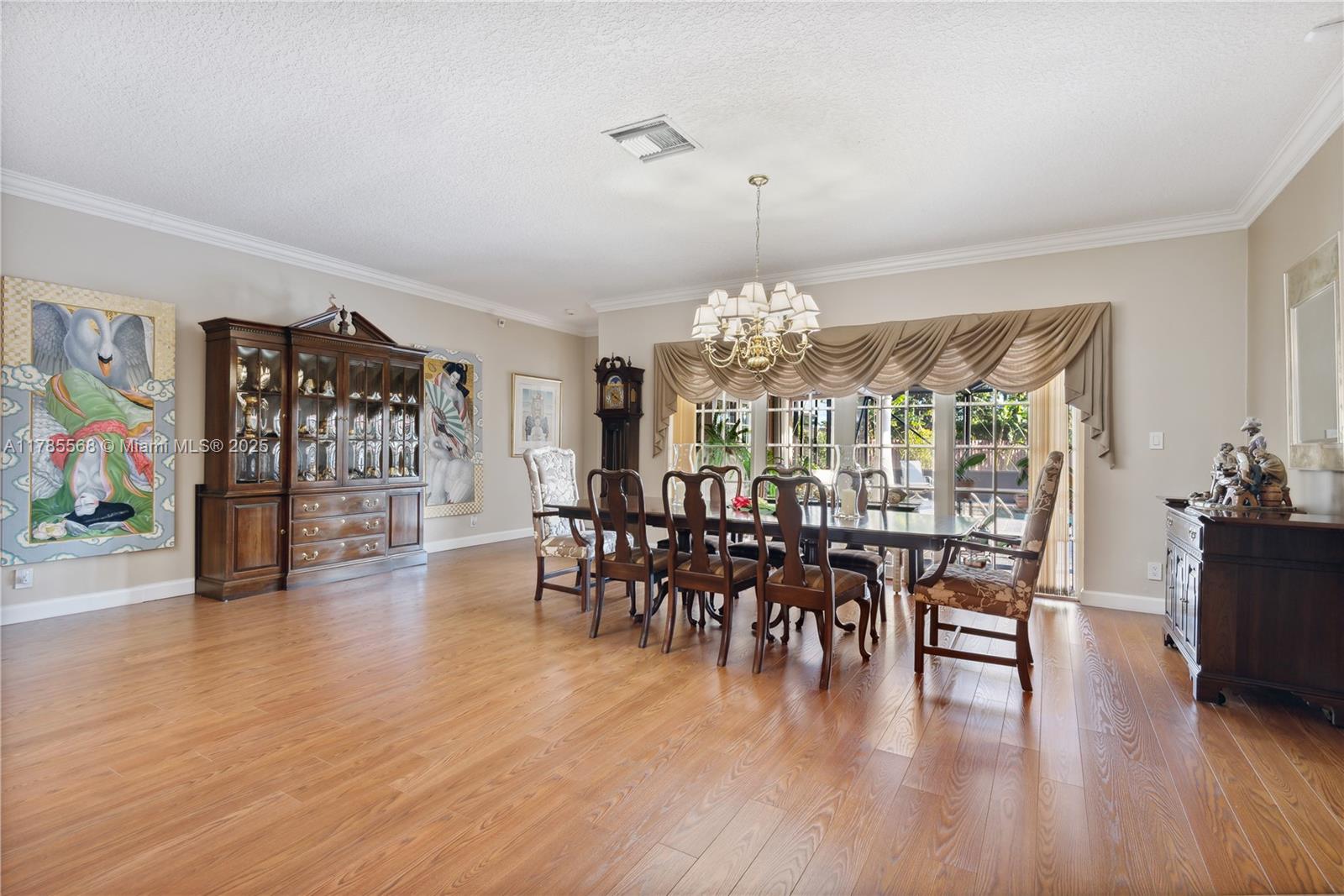 16634 Golfview Drive Weston, FL 33326 - Photo 9 of 29 a view of a dining room with furniture window and wooden floor