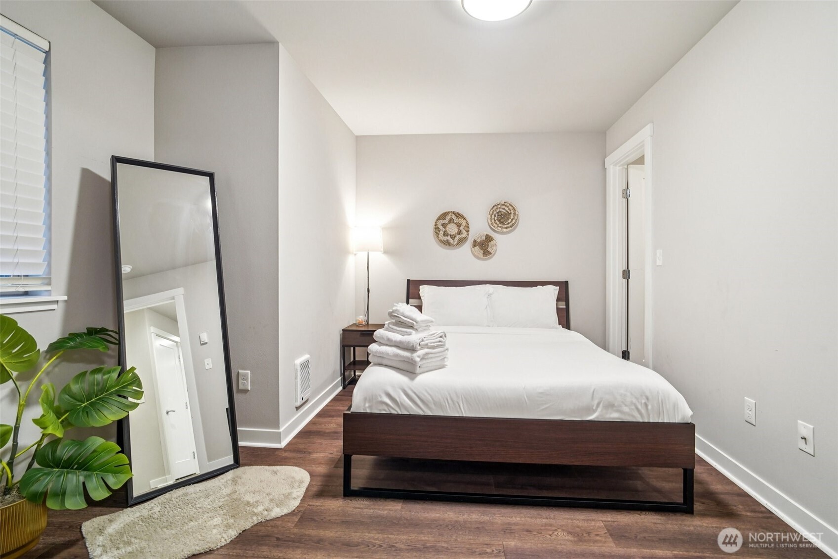 4908 South Willow Street, Unit B Seattle, WA 98118 - Photo 13 of 29 a bedroom with a bed table and a potted plant