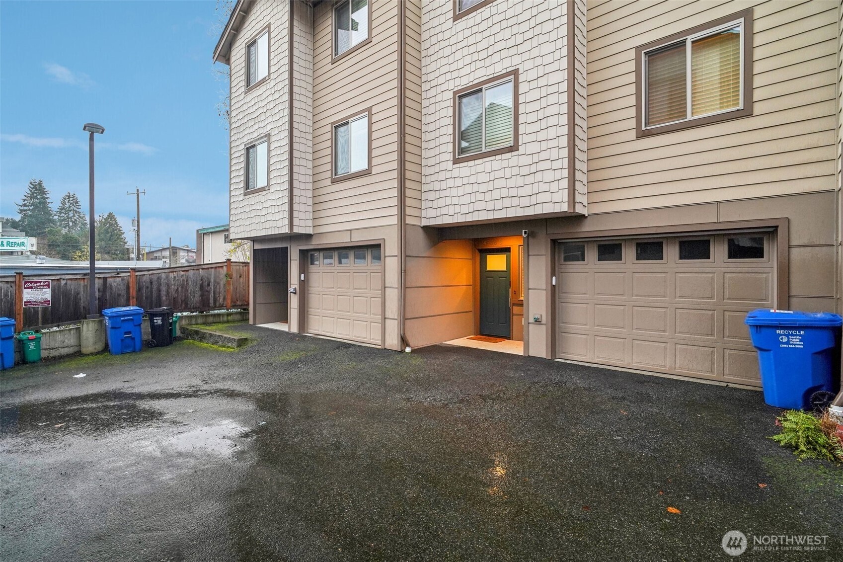 4908 South Willow Street, Unit B Seattle, WA 98118 - Photo 2 of 29 a view of a house with a yard and garage