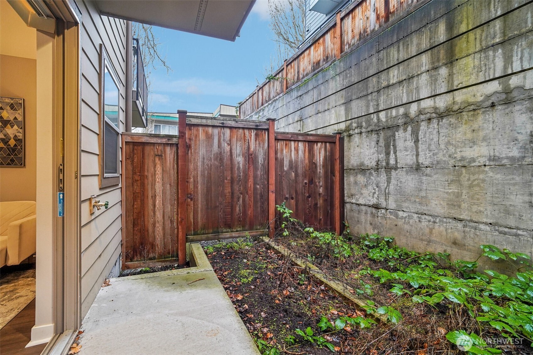 4908 South Willow Street, Unit B Seattle, WA 98118 - Photo 27 of 29 a view of a pathway door with an outdoor space
