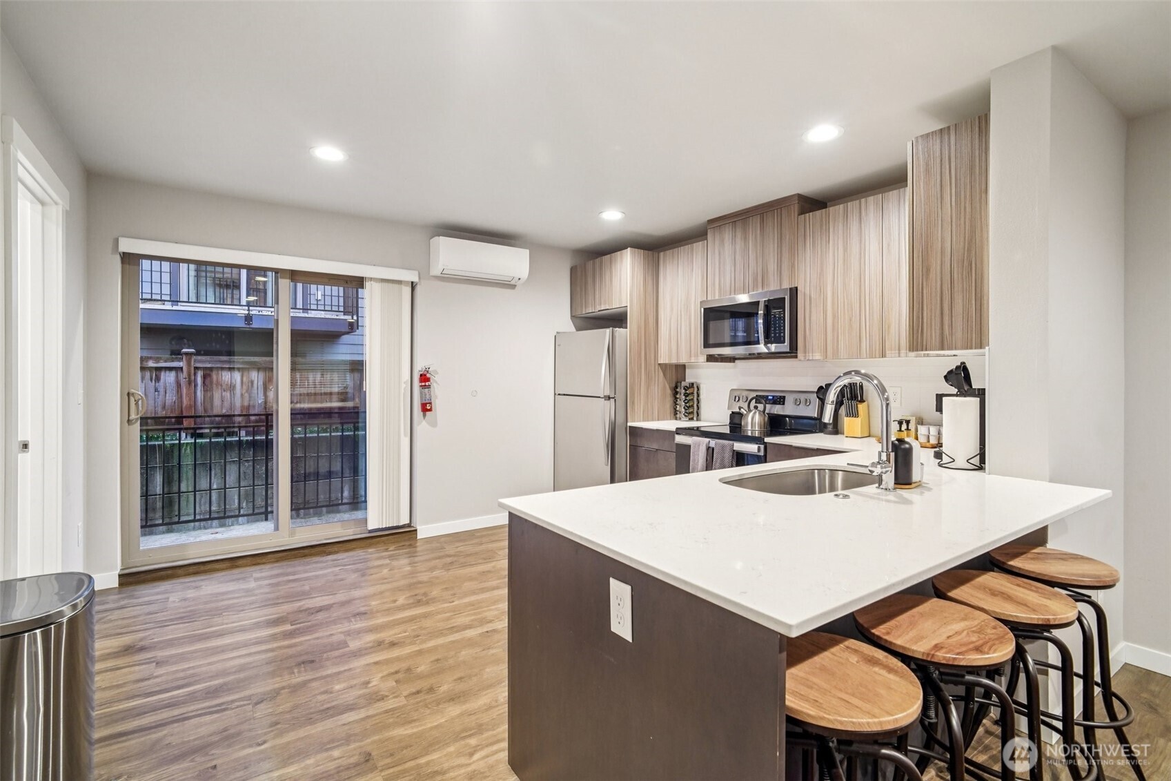 4908 South Willow Street, Unit B Seattle, WA 98118 - Photo 7 of 29 a kitchen with a sink a stove a refrigerator cabinets and wooden floor
