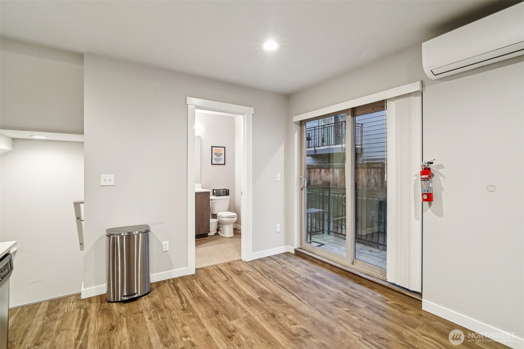 4908 South Willow Street, Unit B Seattle, WA 98118 - Photo 10 of 29 a view of an empty room with wooden floor and a window