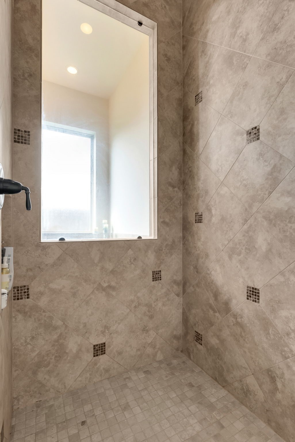 4022 Sabine Valley Trail Spring, TX 77386 - Photo 21 of 46 Spacious shower with elegant beige tile design, featuring a large window for natural light and small accent tiles for added style.